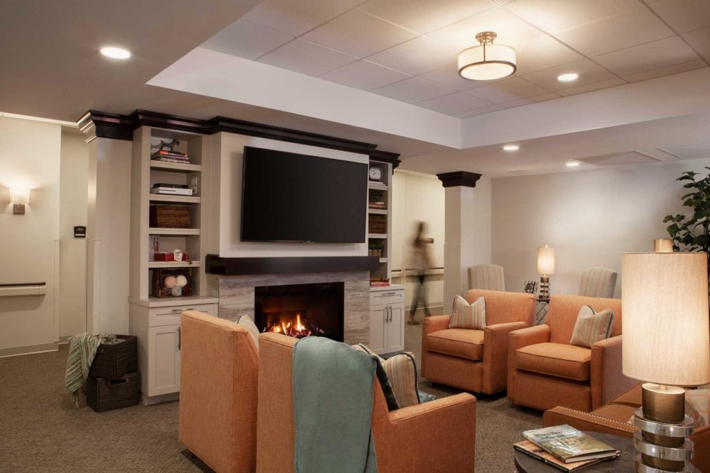 clarendale loung area with tv fireplace and chairs
