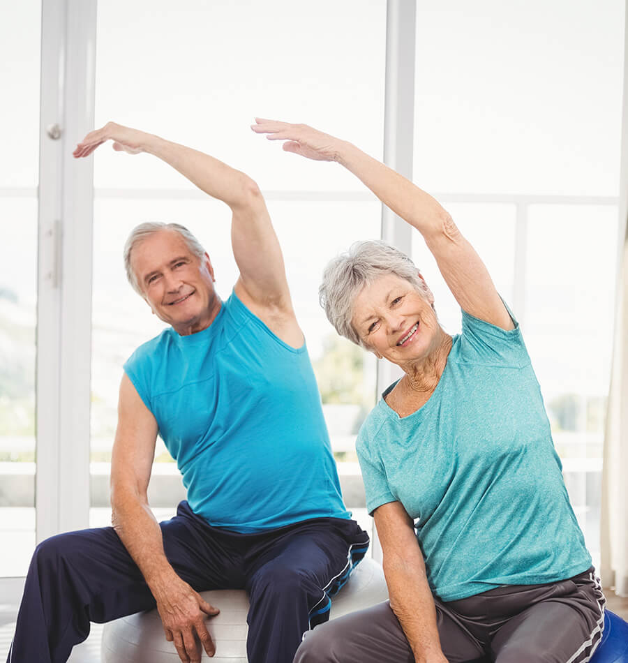 Senior friends stretching over their heads